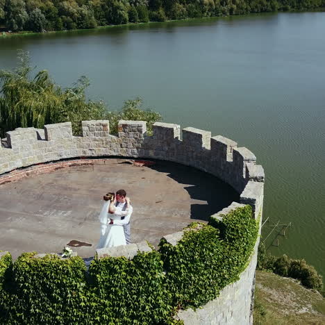 beautiful romantic wedding couple, groom and bride hugging in an old castle. destroyed ancient fortresses square video