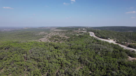 cars drive along fm32 on devil's backbone outside of canyon lake, texas in the hill country