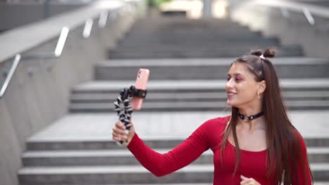 woman taking a selfie on city stairs