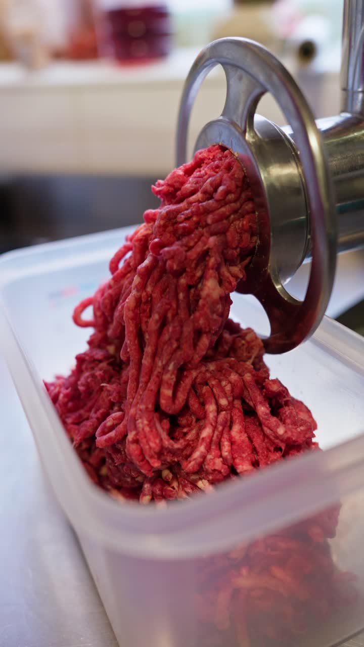 Fresh Ground Meat Coming Out of a Meat Grinder
