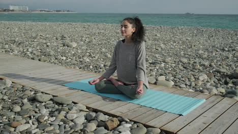 woman meditating on a beach