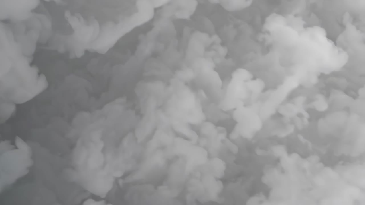 White smoke is filling the frame, creating an abstract background with various shades of gray and white, perfect for digital art and graphic design projects