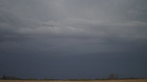 lightning flashing through the dark clouds before the rainstorm. - wide shot
