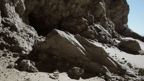 a large cave opening in a desert landscape