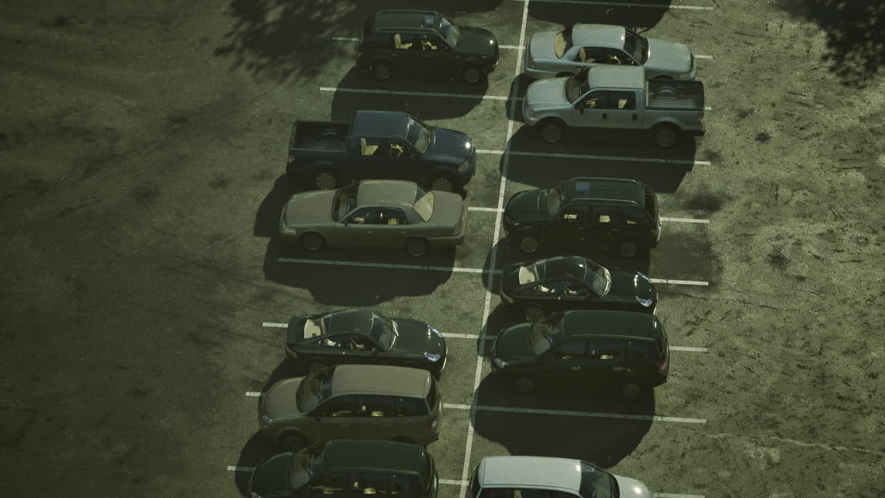 Multiple parked vehicles in a busy lot during midday in a suburban area