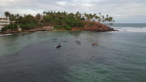 local fisher on small boats on the touristic bay in mirissa, sri lanka, aerial