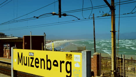 Muizenberg-train-station-with-view-over-beach-full-of-beachgoers