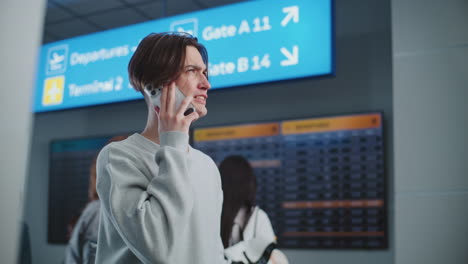 person talking on a phone in an airport terminal