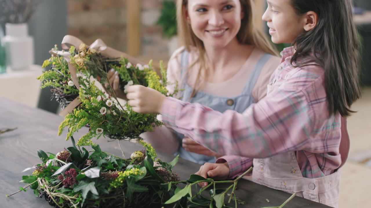 Woman and Girl Making Flower Wreath