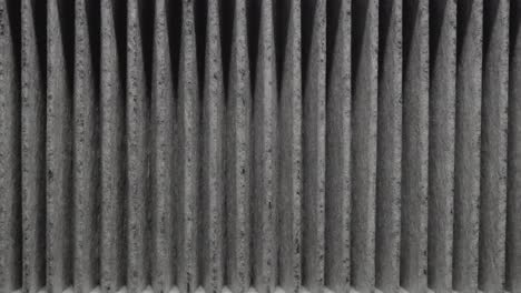 close-up shot of a carbon cabin car air filter rotating on a turntable in the dark