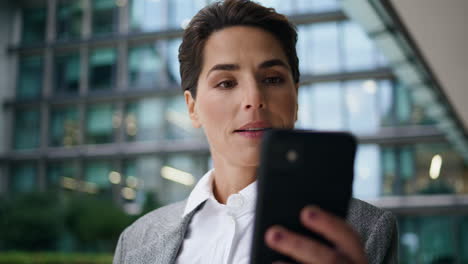 smiling manager making selfie using smartphone closeup. corporate woman resting