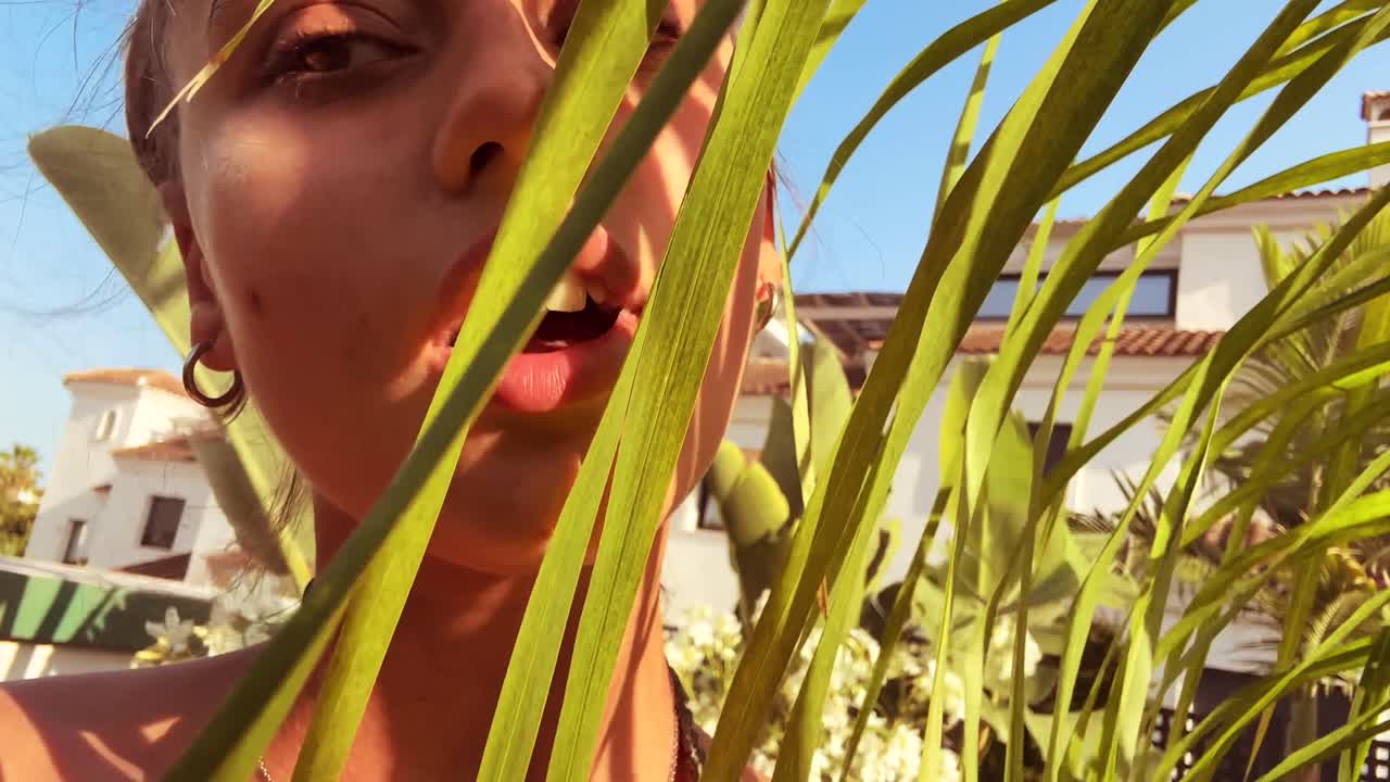 Person with plants in front of a house