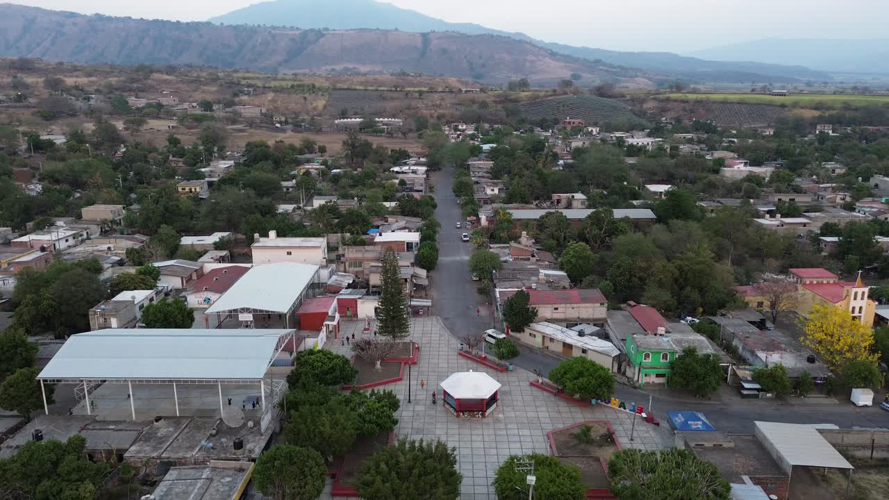"pueblo magico" in Mexico. with a drone the sunset becomes nostalgic, but the golden hour is captured with orange colors that capture the darkness.