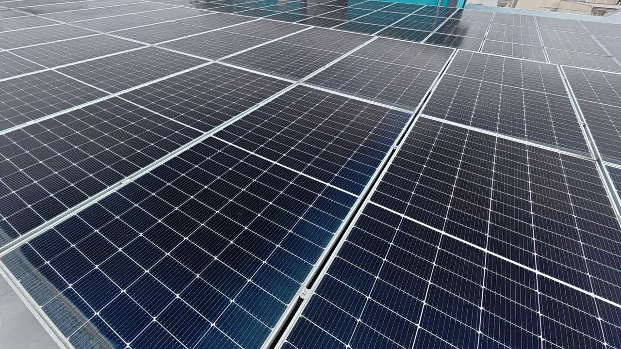 Rows of solar panels installed on a rooftop absorb sunlight, converting it into clean electricity. This sustainable energy source promotes environmental efficiency and supports green living.