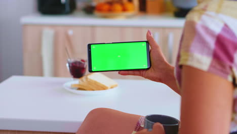 Mujer-Sostiene-Un-Gadget-De-Pantalla-Verde