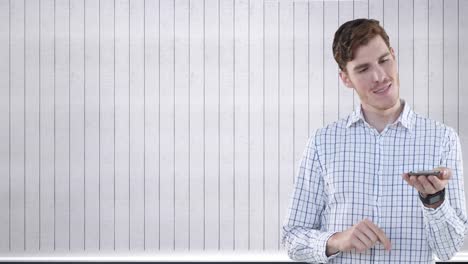 Video-of-happy-caucasian-man-with-smartphone-over-white-wooden-background