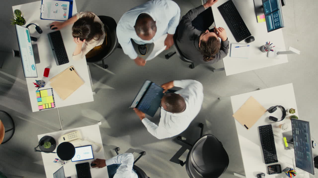 Vertical Video Top down view zoom in of business people discuss development analytics