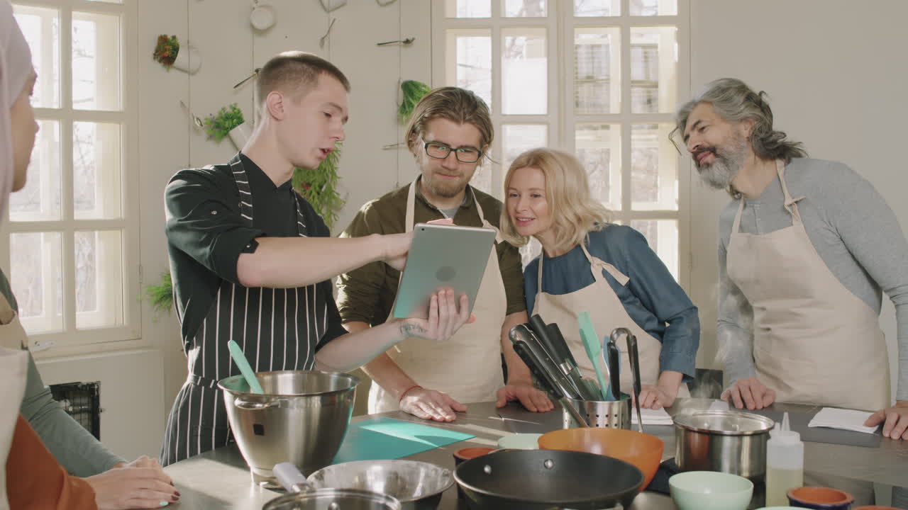 Male Chef Teaching Cooking At Culinary School