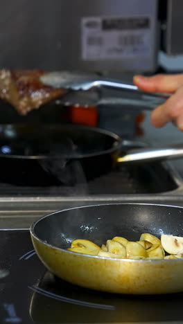 chef cooking steak and mushrooms