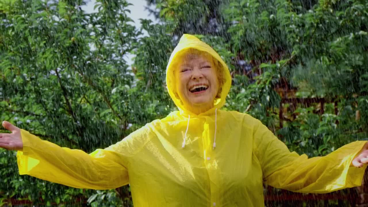 Senior woman enjoying a rain shower