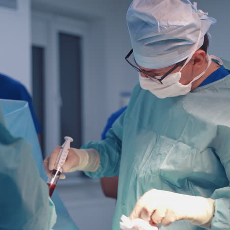 operation bone marrow transplant. group of surgeons in operating room with surgery equipment. plasma in syringe.