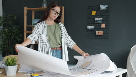 female architect reviewing building plans