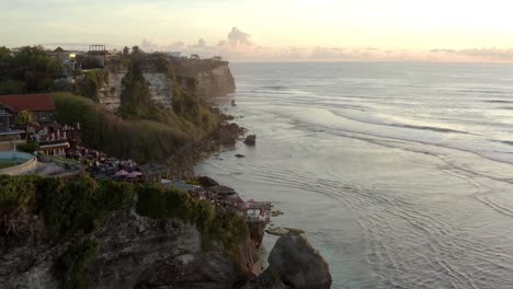 aerial view of the famous limestone cliff of the suluban coast during sunset in uluwatu bali indonesia