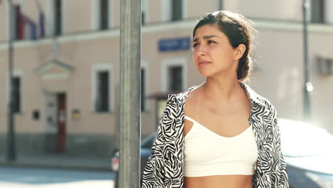 woman in zebra print outfit on city street