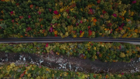 scenic aerial view over kancamagus highway near river and colorful foliage