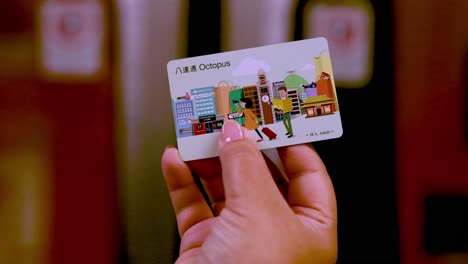 person displays octopus card in hand