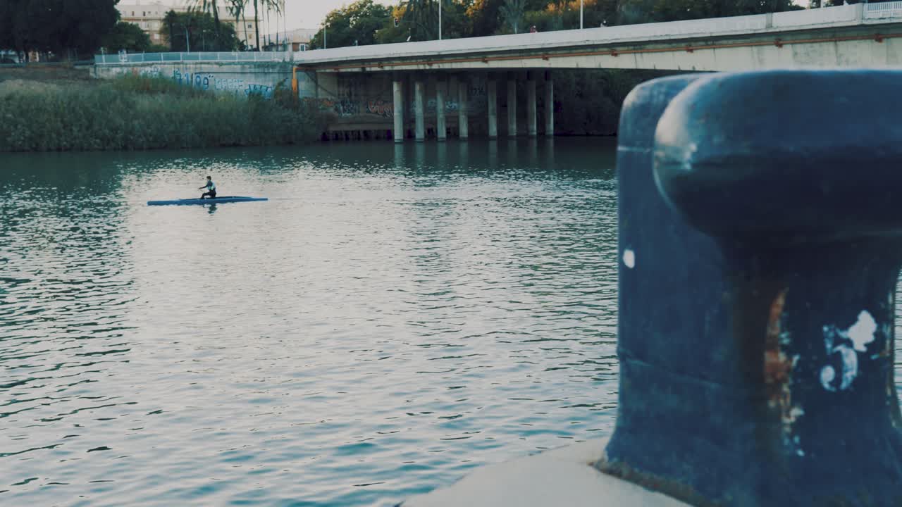 Canoeing in the city river, kayaking in Seville in very calm blue waters. Spain and Andalusia with sports tourism