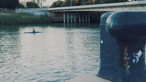 canoeing in the city river, kayaking in seville in very calm blue waters. spain and andalusia with sports tourism