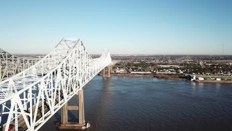 Crescent-City-Connection-Bridge-Over-Mississippi-River-With-Boland-Marine-Perry-Street-Wharf-In-The-Distance-In-Louisiana,-USA