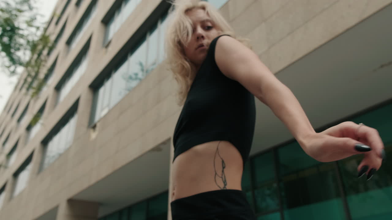 Young Woman Dancing Expressively in Urban City Environment