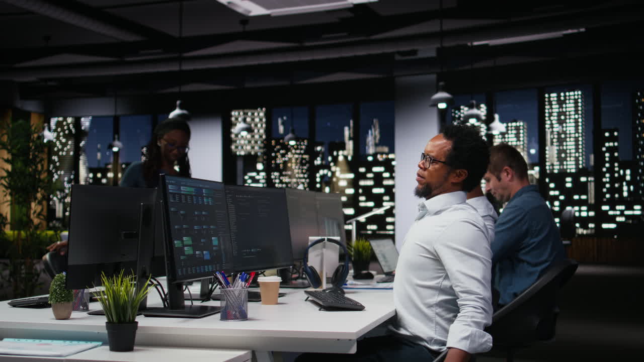 African American Programmer Working Late Night in Modern Office