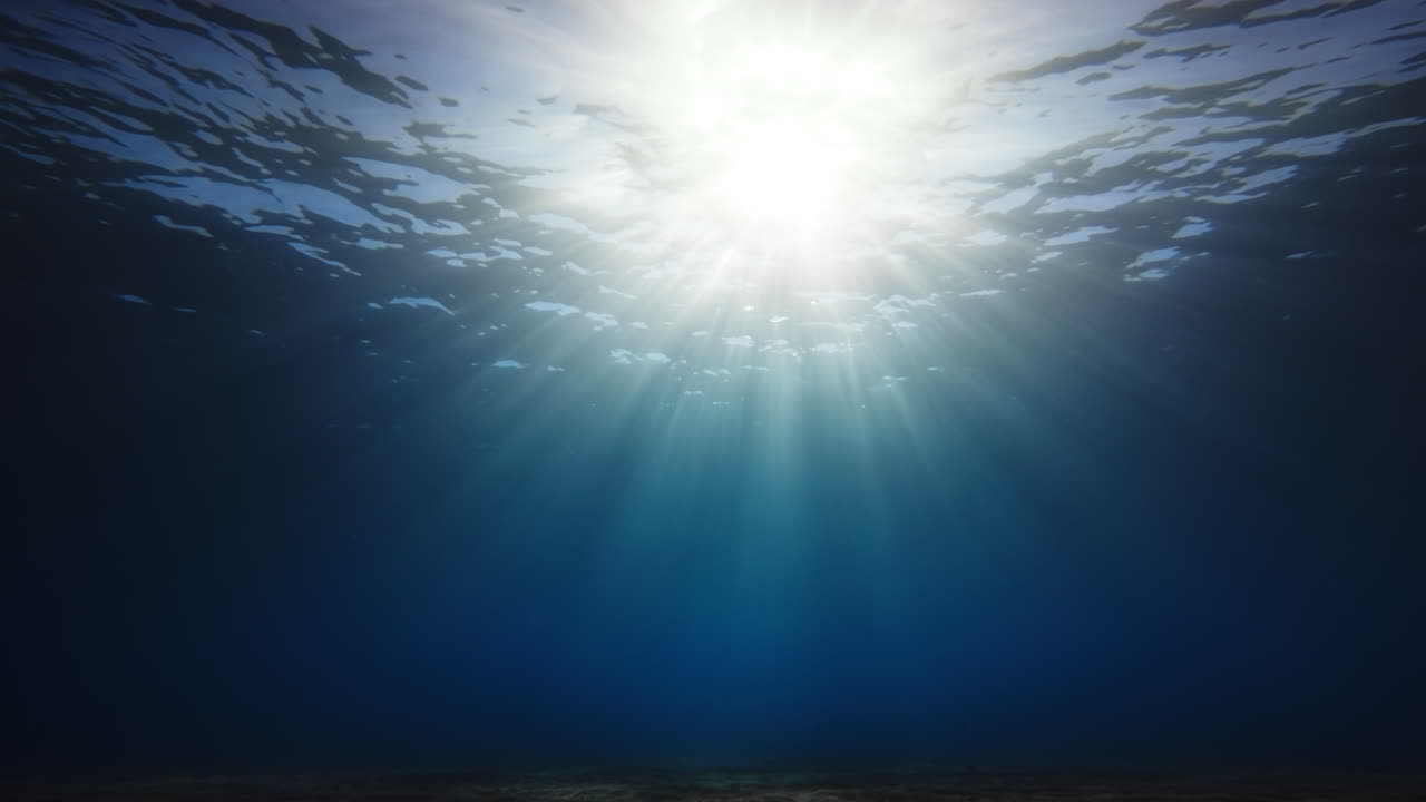Sunlight Breaks Through Calm Ocean for a Relaxing Background