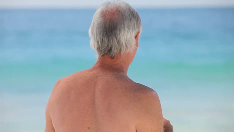 mature man looking through binoculars