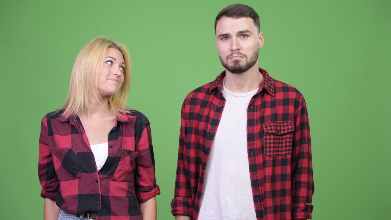 Young woman presenting young man together