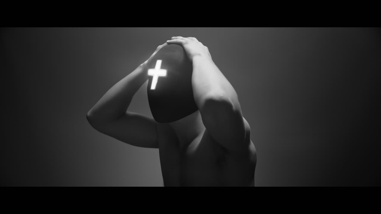 Masked man with cross of light glowing on his face moves slowly