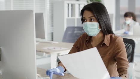 Video-of-woman-working-in-an-office-during-a-pandemic