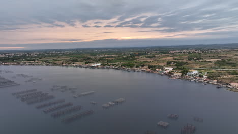 Aerial-perspective:-Etang-de-Thau's-oyster-farms-twinkle-in-the-evening's-fading