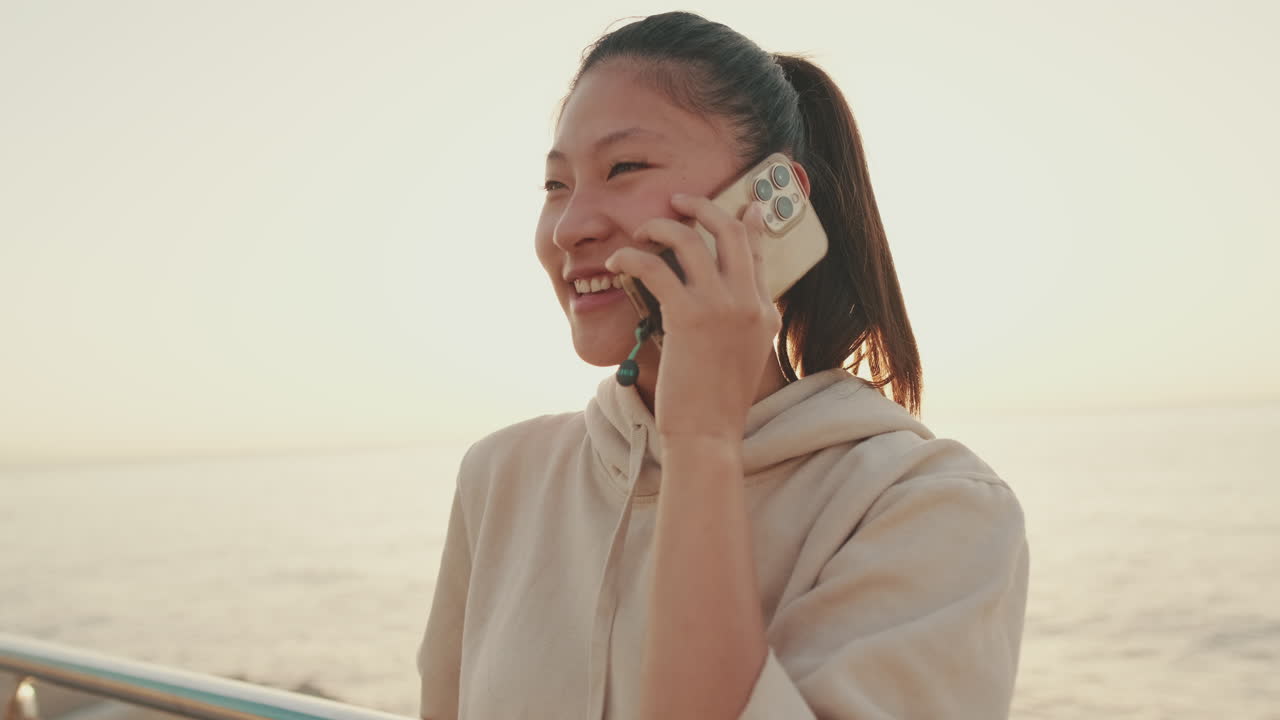 Woman talking on the phone at the beach