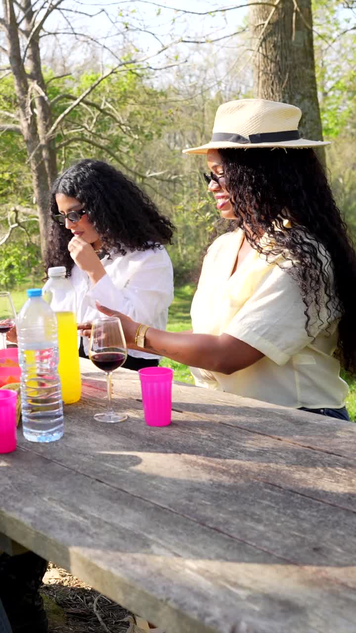 Friends Having Picnic in Park Taking Pictures