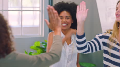 women celebrating success in a meeting