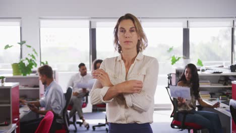 Professional-businesswoman-standing-with-her-hands-folded-in-modern-office-in-slow-motion