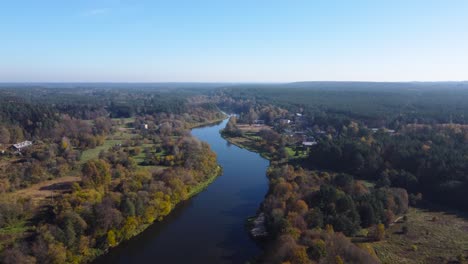 aerial slow fly-by of a river nėris meandering through autumnal forests in vilnius, lithuania