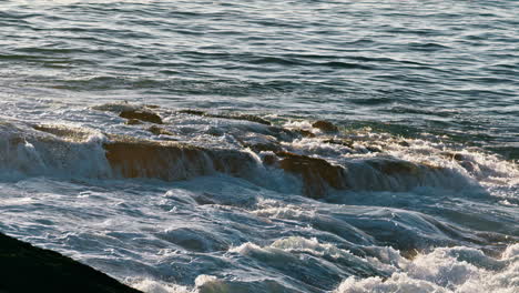 Deep-river-flowing-sunrise-nature-close-up.-Ocean-water-running-through-stone