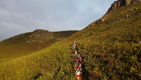 group of hikers climb a mountain