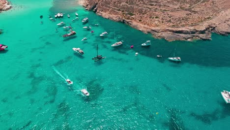 a stunning aerial view of boats anchored near a rocky coastline