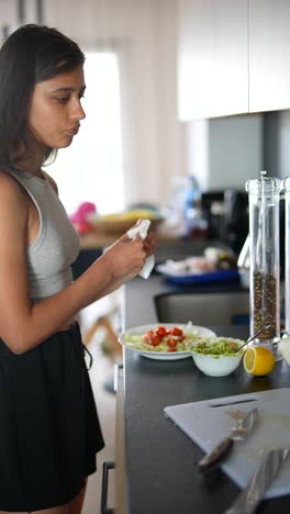 teenager cooking a salad in a kitchen